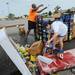 Big Fireworks employees Randy Williams and Alina Coon sort through ruined boxes of fireworks runied after strong winds and heavy rains knocked over the tent at Big Fireworks on Thursday morning.  Melanie Maxwell I AnnArbor.com